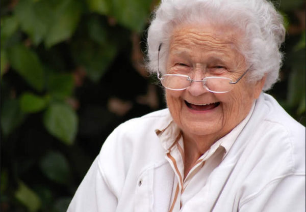 smiling elderly woman wearing glasses
